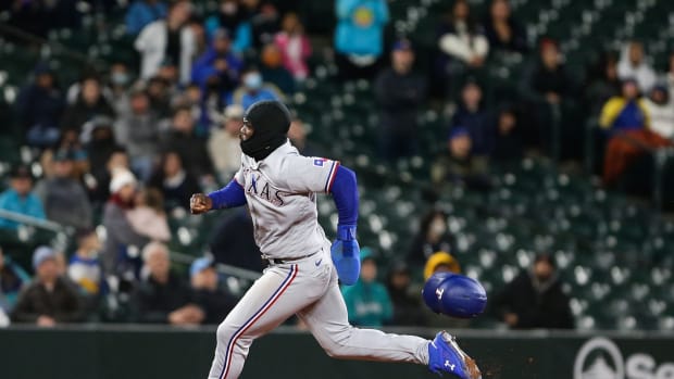 Apr 21, 2022; Seattle, Washington, USA; Texas Rangers right fielder Adolis Garcia (53) rounds the bases to score on a double by Texas Rangers right fielder Kole Calhoun (56) during the ninth inning against the Seattle Mariners at T-Mobile Park. Mandatory Credit: Lindsey Wasson-USA TODAY Sports